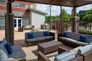 a patio with couches and chairs on a patio at Residence Inn by Marriott Charlotte Airport in Charlotte