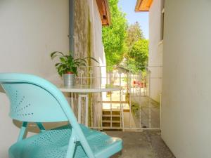 uma cadeira azul sentada ao lado de uma mesa na varanda em O2 Hostel em Porto