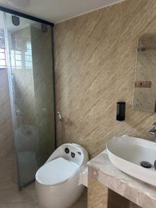 a bathroom with a toilet and a sink at Azreen Tower in Chittagong +34 photos