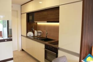 a kitchen with white cabinets and a counter top at Apartment Patricia in Vodice