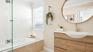 a bathroom with a sink and a mirror at The Salty Perch in Callala Beach