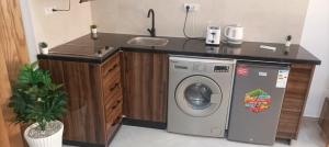 a kitchen with a sink and a washing machine at Modern Studio in Kenitra Center Netflix & IPTV in Kenitra