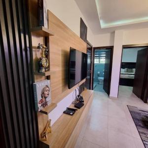 a living room with a tv on a wall at Aurora flat lekki in Lekki Phase 1 +10 photos