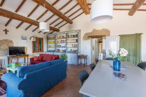 a living room with a blue couch and a table at Italian Experience- Poggio Padule in San Venanzo