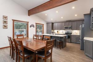 a kitchen with a wooden table and chairs in a room at Aspen in Valemount