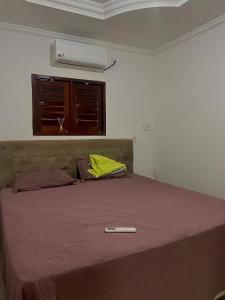 a bedroom with a bed with a thermometer on it at Apartamento Alto de São Manoel in Mossoró