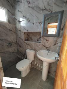 ein Marmorbad mit einem WC und einem Waschbecken in der Unterkunft maison de baraka in Al Ḩārah al Kabīrah