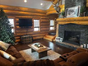 a living room with a couch and a fireplace at Southview Lodge in Valemount