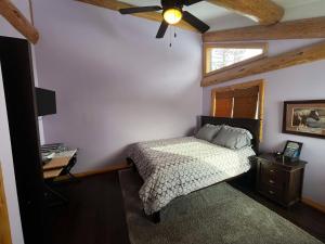 a bedroom with a bed and a ceiling fan at Southview Lodge in Valemount