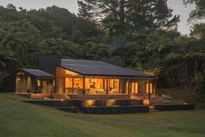 a modern house with a black roof at Lakefront Luxury at Okere Falls Lake Rotoiti in Rotorua
