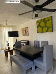 a dining room table with chairs and a ceiling fan at Joyas Vallarta Coto Frente a Vidanta Worl in Jarretadera
