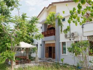 an image of a house with a balcony at D SeBalik Pulau Tropical Boutique Home in Balik Pulau