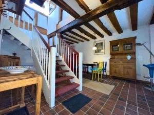 a room with a staircase and a dining room at Ferienhaus Emma im Morsbacher Hof in Morsbach