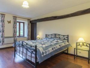 a bedroom with a bed and two night stands at Normandy Countryside Stay in Montaigu-les-Bois