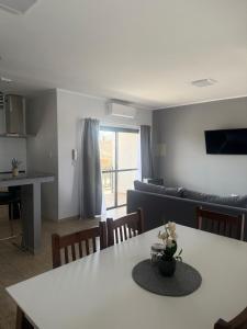 a kitchen and living room with a table and a couch at PLUM APART in San Rafael +32 photos