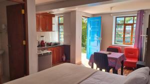 a room with a kitchen with a table and chairs at Cottage in nature in Sacred Valley with mountain views in Huayllabamba