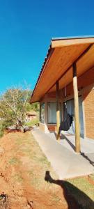 a porch of a house with a roof at Chalé Black Touch in Santo Antônio do Pinhal