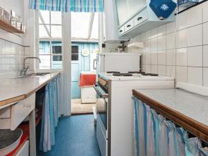a kitchen with a sink and a stove top oven at 4 person holiday home in Odder-By Traum in Odder +29 photos
