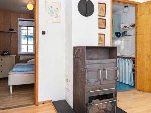 an old stove in a kitchen with a bedroom at 4 person holiday home in Odder-By Traum in Odder