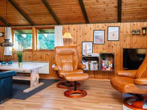 a living room with a chair and a table at 6 person holiday home in Knebel-By Traum in Knebel