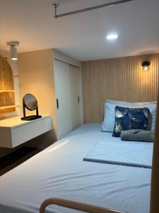 a bedroom with a large white bed with blue pillows at Iloilo Condo for Group Stay in Iloilo City