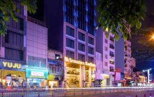 a city street at night with buildings at Winsuites Saigon Hotel in Ho Chi Minh City
