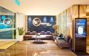a living room with couches and a table at Winsuites Saigon Hotel in Ho Chi Minh City +83 photos