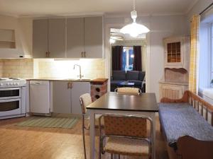 a kitchen and living room with a table and chairs at 4 person holiday home in LUR-By Traum in Lur