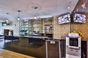 a large room with a tv and a cash register at Q Collection Macalister formerly known as Apple Hotel Penang in George Town