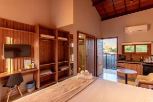 a living room with a bed and a television at Vila Diamantina in Mucugê