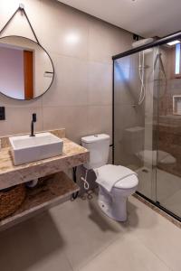 a bathroom with a toilet and a sink and a shower at Vila Diamantina in Mucugê
