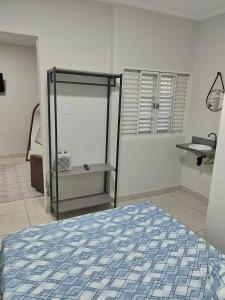 a bedroom with a blue and white bed in a room at Apartamento loft in Poços de Caldas