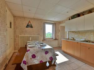 a kitchen with a table with plates and glasses on it at Appartement à Neuvecelle avec balcon, parking et vue lac - FR-1-498-119 in Neuvecelle