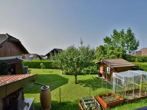 a garden with a greenhouse and a house at Appartement à Neuvecelle avec balcon, parking et vue lac - FR-1-498-119 in Neuvecelle