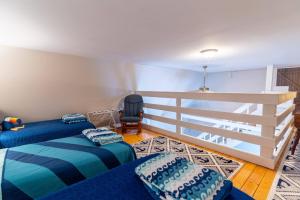 a bedroom with two beds and a white fence at Charming Waterfront Cabin - Sleeps 10 in Rocky Mount