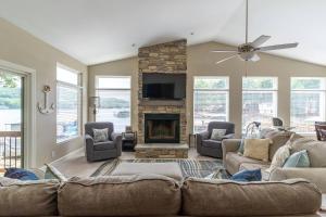 a living room with a couch and a fireplace at Charming Waterfront Cabin - Sleeps 10 in Rocky Mount