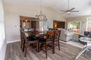 a dining room and living room with a table and chairs at Charming Waterfront Cabin - Sleeps 10 in Rocky Mount