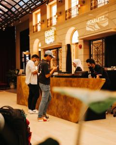 a group of men standing at a counter in a store at Luxury Scarletz Suites KLCC in Kuala Lumpur
