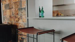 a kitchen with two bottles of wine on a shelf at Dusk Coffin Bay in Coffin Bay
