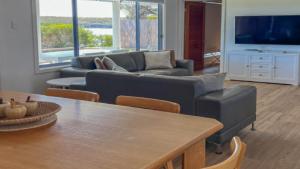 a living room with a couch and a table at Wrightaway in Coffin Bay