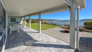 an outdoor patio with a view of the ocean at Wrightaway in Coffin Bay