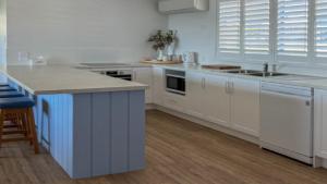 a kitchen with white cabinets and a counter top at Wrightaway in Coffin Bay