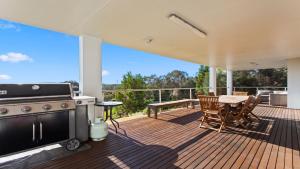 a patio with a grill and a table on a deck at Endeavour View Is A Fantastic - A Modern, 4 Bedroom Holiday Home in Coffin Bay