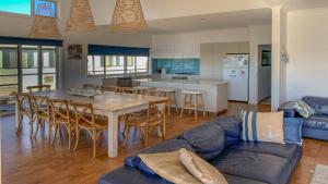 a kitchen and living room with a table and a couch at Angasi Is One Of Coffin Bay's Premium Properties - With Free Wifi in Coffin Bay +16 photos