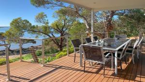 a patio with a table and chairs on a deck at Angasi Is One Of Coffin Bay's Premium Properties - With Free Wifi in Coffin Bay