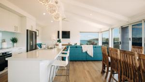 a kitchen and living room with a blue couch at Dolphinview in Coffin Bay +16 photos