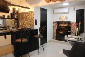 a kitchen with a bar and a fireplace at Hotel Las Americas in Aguascalientes