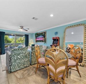 a living room with a couch and chairs and a mirror at Bayview Condo, Boat Slip & Launch, Pool & Arcade! The Wild Wahoo! in Orange Beach