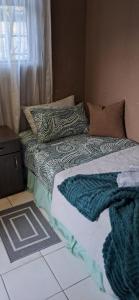 a bed with two pillows on top of it at Clay Stone Cottage in Goodwood