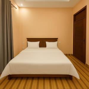 Ένα ή περισσότερα κρεβάτια σε δωμάτιο στο Amada Kigali Luxury Apartments